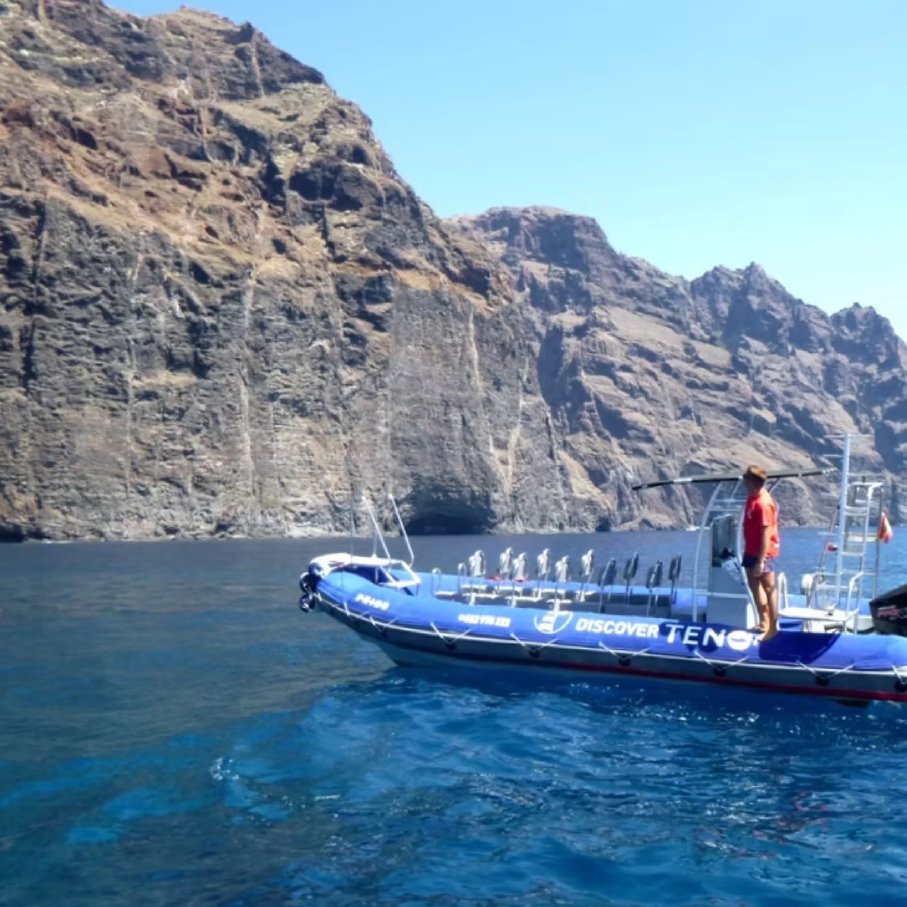 Blue Discover Teno boat in front of the Los Gigantes cliffs